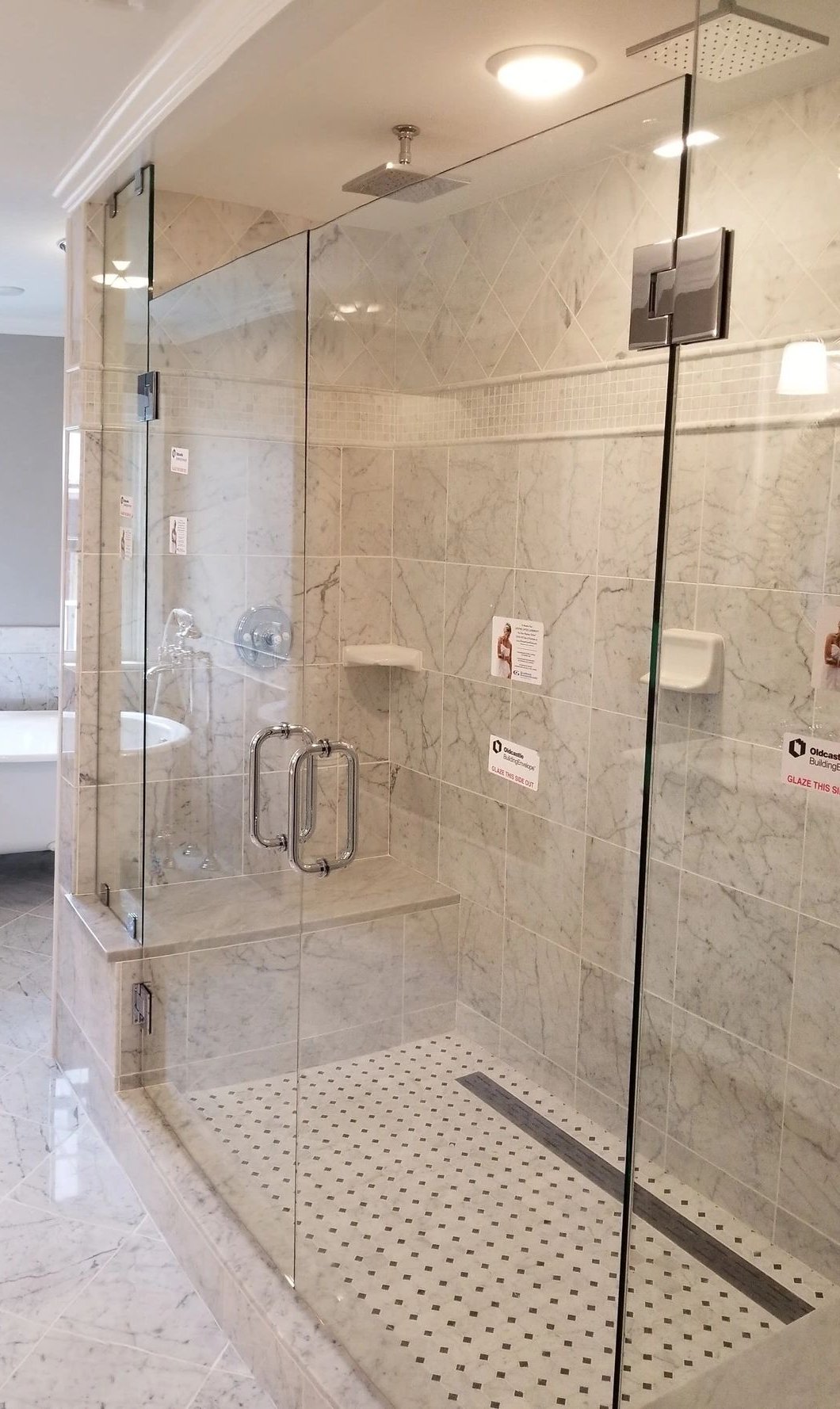 Frameless glass shower with marble tile